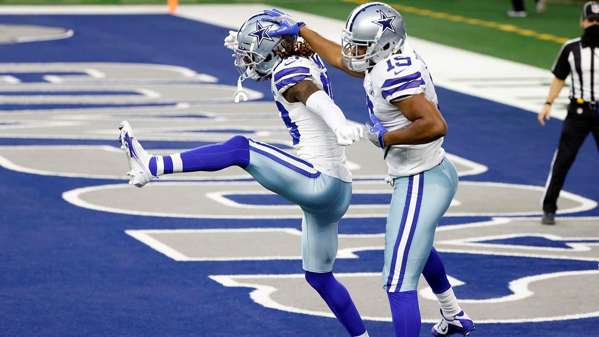 Dallas Cowboys wide receiver CeeDee Lamb (88) and wide receiver Amari Cooper (19) celebrate a touchdown catch by Lamb in the second half of an NFL football game against the Philadelphia Eagles in Arlington, Texas, Sunday, Dec. 27. 2020. (AP Photo/Ron Jenkins)