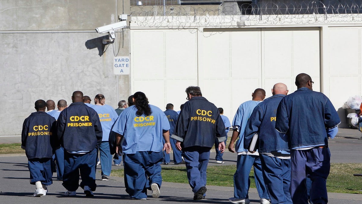 In this Feb. 26, 2013, file photo, inmates walk through the exercise yard at California State Prison Sacramento, near Folsom, Calif. The California Supreme Court ruled Monday, Dec. 28, 2020, that inmates convicted of what the state defines as nonviolent sex crimes cannot be denied a chance at earlier release under a ballot measure approved by nearly two-thirds of voters four years ago.