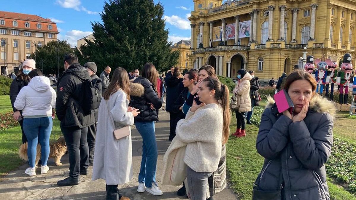 Residents gather outside after an earthquake at a square in downtown Zagreb, Croatia, Tuesday, Dec. 29, 2020. A strong earthquake hit Croatia on Tuesday, with some injuries reported as well as considerable damages to roofs and buildings southeast of the capital. (AP Photo/Filip Horvat)