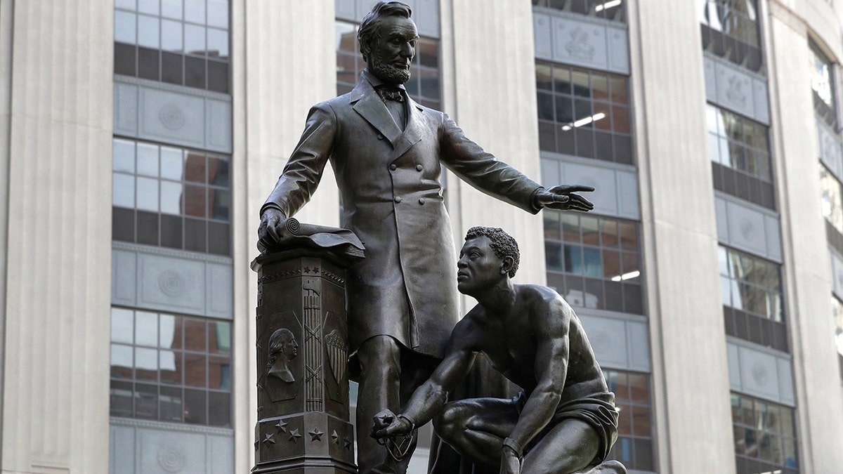 In this June 25, 2020, file photo, a statue that depicts a freed slave kneeling at President Abraham Lincoln's feet rests on a pedestal in Boston. On Tuesday, Dec. 29, the statue was removed from its perch. (AP Photo/Steven Senne)