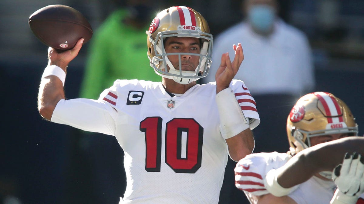 FILE - In this Nov. 1, 2020 file photo, San Francisco 49ers quarterback Jimmy Garoppolo passes against the Seattle Seahawks during the first half in Seattle.