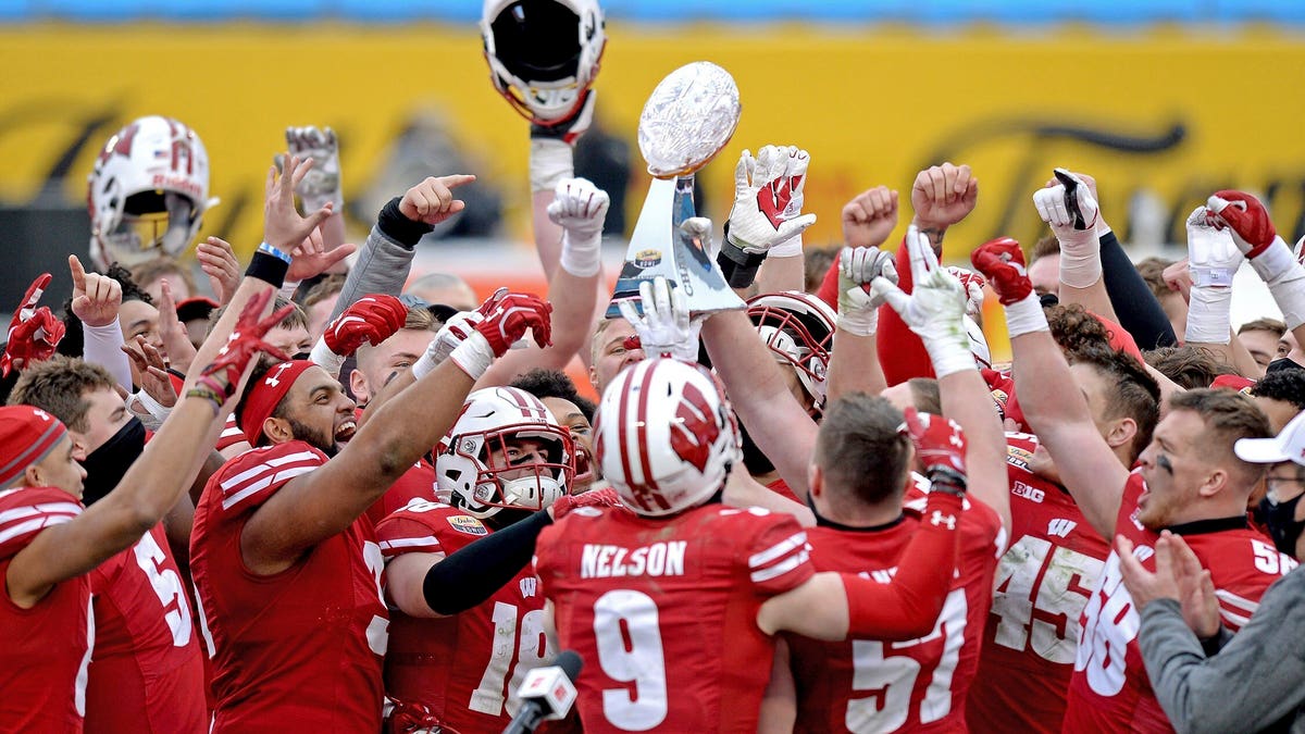 Wisconsin players hoist the trophy following victory over Wake Forest in the Duke's Mayo Bowl NCAA college football game at Bank of America Stadium in Charlotte, N.C., Wednesday, Dec. 30, 2020. (Associated Press)