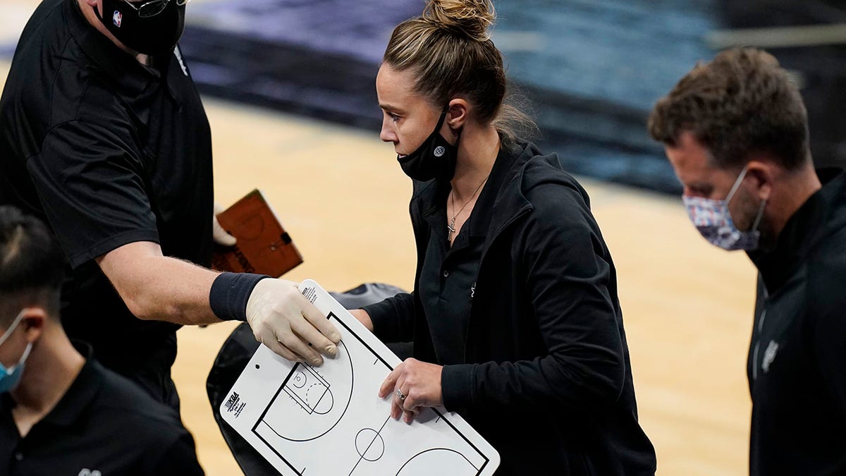 San Antonio Spurs assistant coach Becky Hammon breaks from a huddle during a timeout in the second half of an NBA basketball game against the Los Angeles Lakers in San Antonio, Wednesday, Dec. 30, 2020. Hammon became the first woman to direct an NBA team, taking over the Spurs after coach Gregg Popovich was ejected in a 121-107 loss to the Lakers. (Associated Press)