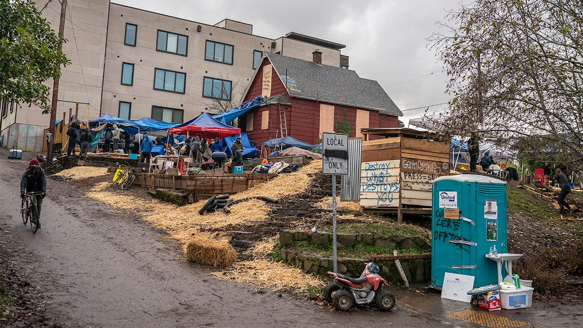 Protesters build defensive structures around the Red House on Mississippi on Dec. 9 in Portland, Oregon. Police and protesters clashed during an attempted eviction Tuesday, leading protesters to establish a barricade around the Red House. (Photo by Nathan Howard/Getty Images)