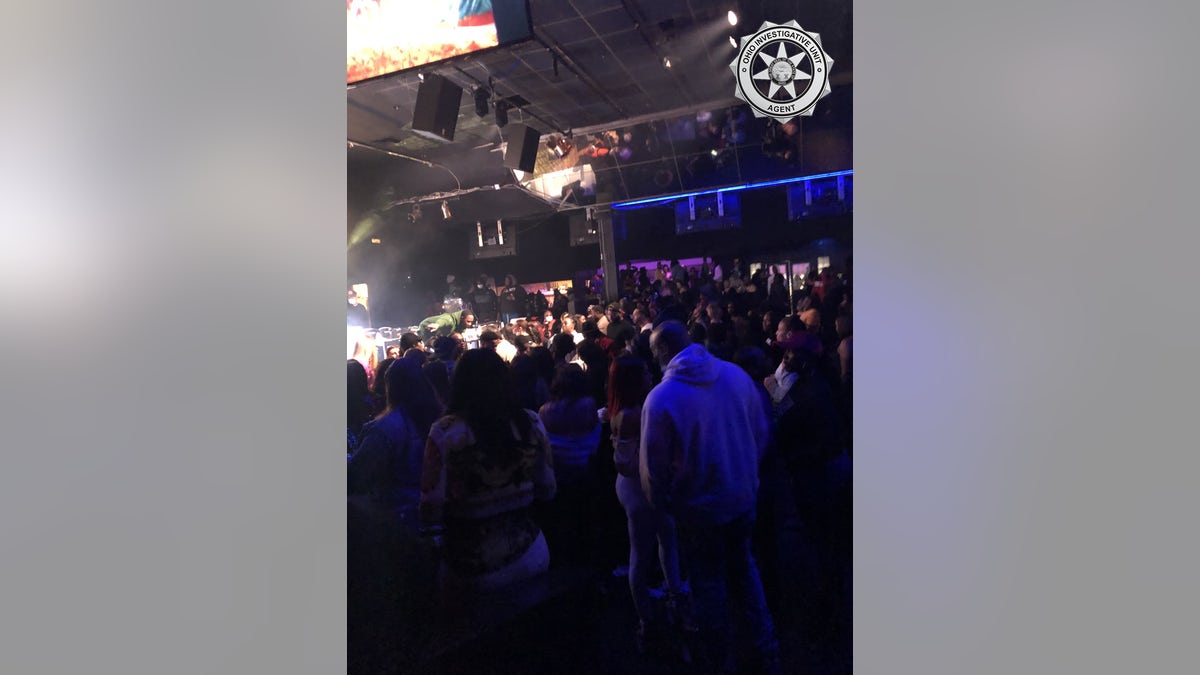 Patrons attend the Aftermath nightclub for a concert that violated COVID-19 restrictions.