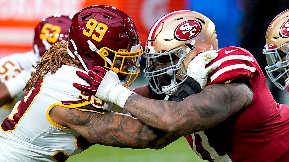 Washington Football Team defensive end Chase Young (99) and San Francisco 49ers offensive tackle Trent Williams battle during the first half of an NFL football game, Sunday, Dec. 13, 2020, in Glendale, Ariz. (AP Photo/Ross D. Franklin)