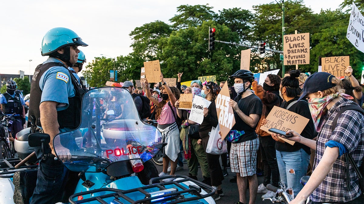Protesters chant and wave signs at the Chicago Police Department during a protest in June. It was the 12th day of protests since George Floyd died in Minneapolis police custody. (Photo by Natasha Moustache/Getty Images)