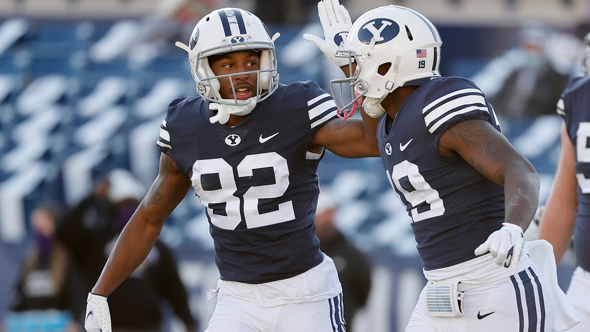 BYU wide receiver Chris Jackson (82) congratulates running back Miles Davis (19) after his touchdown in the third quarter against North Alabama during an NCAA college football game Saturday, Nov. 21, 2020, in Provo, Utah. (AP Photo/Jeff Swinger, Pool)