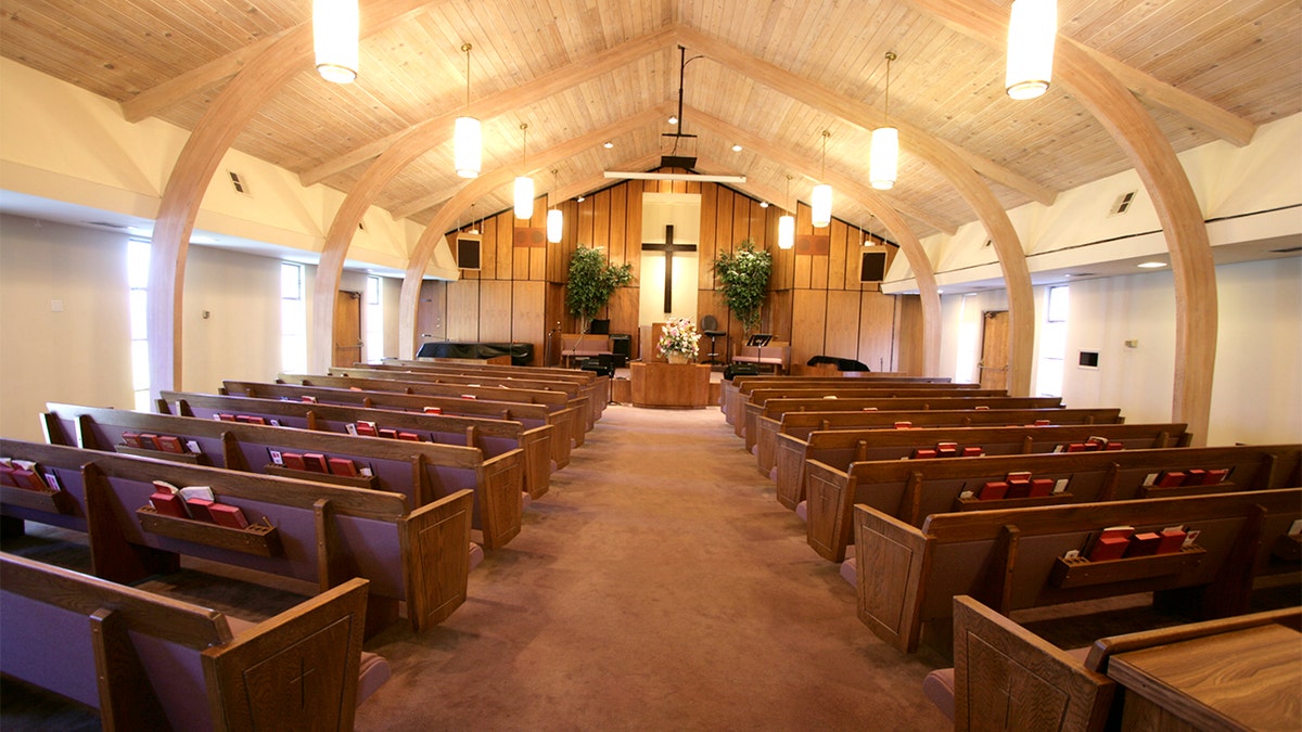 Sanctuary of a small church with pews and pulpit