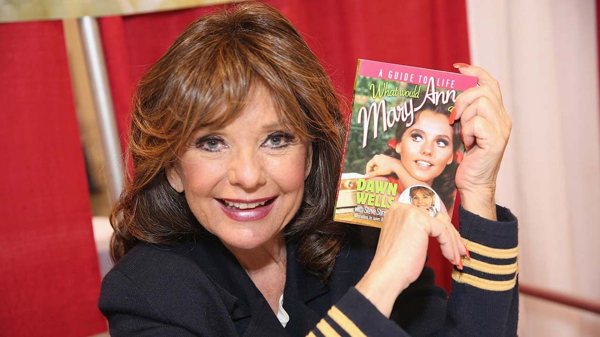 Dawn Wells in 2014, with her book 'What Would Mary Ann Do? A Guide to Life,' which she co-wrote with Steve Stinson.