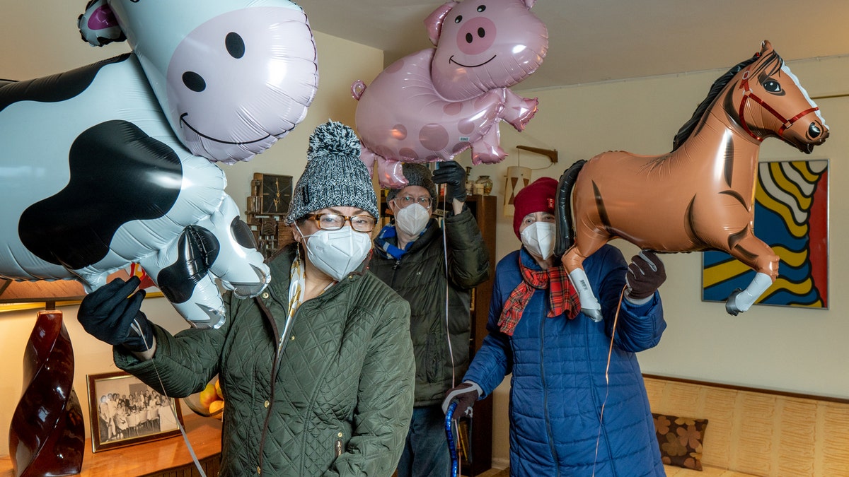 This photo shows the trio holding their own mini Macy's Thanksgiving Day Parade.