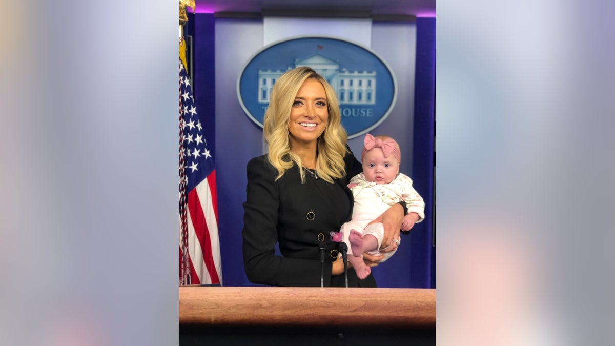 McEnany and her daughter, Blake, at the podium in the White House press briefing room after her first briefing on May 1, 2020.