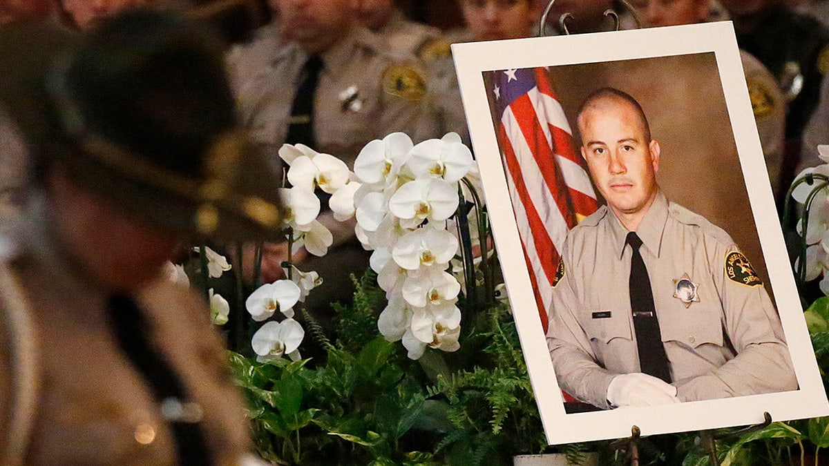  A portrait sits next to the casket of Los Angeles County Sheriffs Deputy Joseph Solano during a memorial service Monday morning June 24, 2019 at Cathedral of Our Lady of the Angels in Los Angeles. (Al Seib / Los Angeles Times via Getty Images)