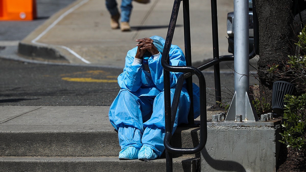 FILE -- NEW YORK, N.Y. APRIL 1: A sad and tired health care worker is seen by the Brooklyn Hospital Center in New York. (Photo by Tayfun Coskun/Anadolu Agency via Getty Images)