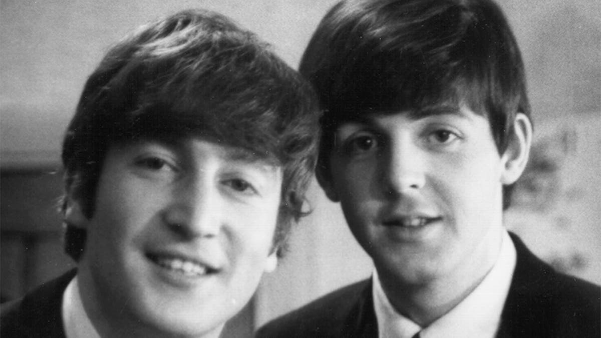 Paul McCartney and John Lennon (1940-1980) from The Beatles posed backstage at the Finsbury Park Astoria, London during the band's Christmas Show residency on December 30, 1963.