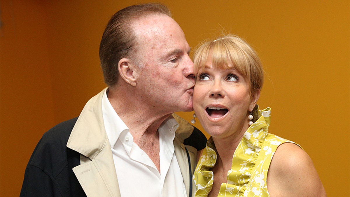 Frank Gifford and Kathie Lee Gifford take a photo together