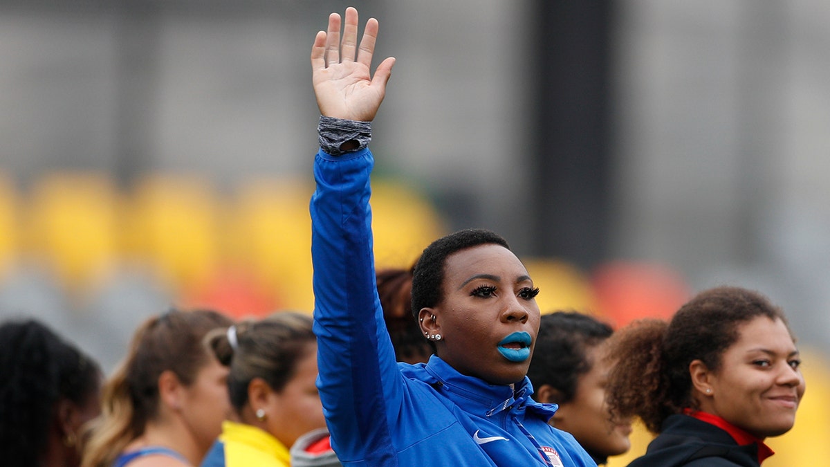 In this Aug. 10, 2019, file photo, Gwen Berry of the United States waves as she is introduced at the start of the women's hammer throw final during athletics competition at the Pan American Games in Lima, Peru. 