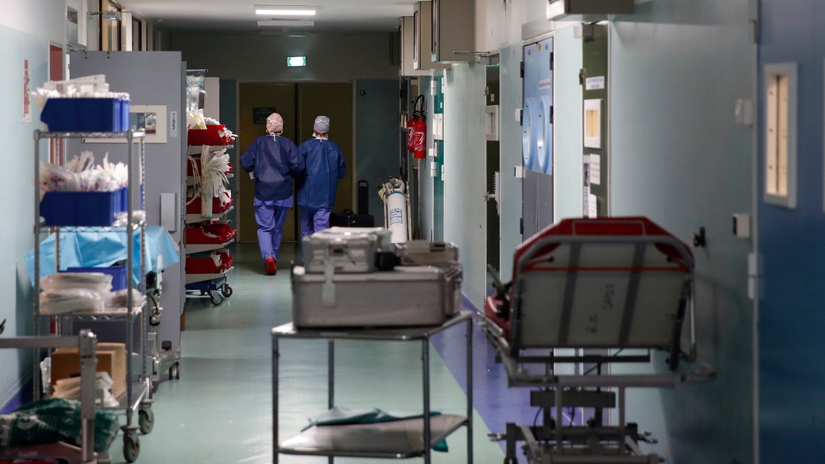 Medics walk along a corridor at Bichat Hospital, AP-HP, in Paris.