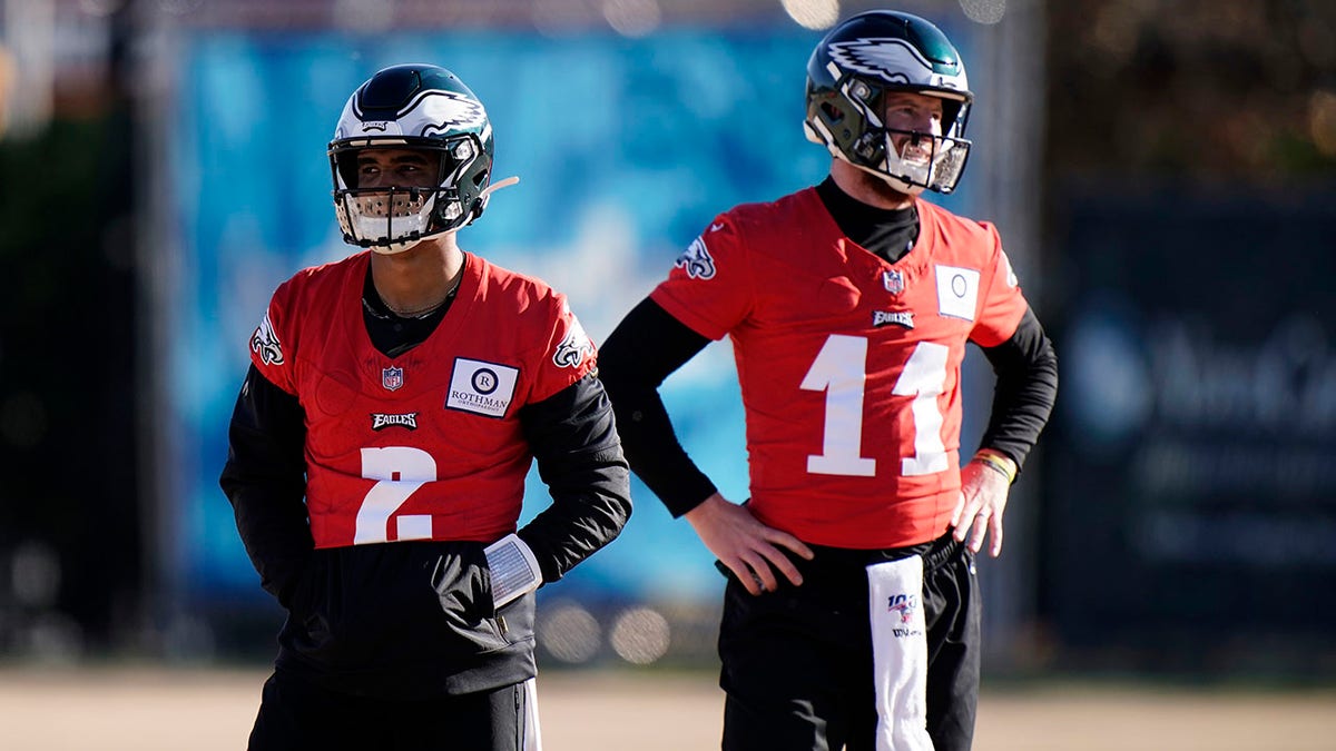 Philadelphia Eagles' Jalen Hurts, left, and Carson Wentz watch a drill during practice at the NFL football team's training facility, Thursday, Dec. 10, 2020, in Philadelphia. (AP Photo/Matt Slocum, Pool)