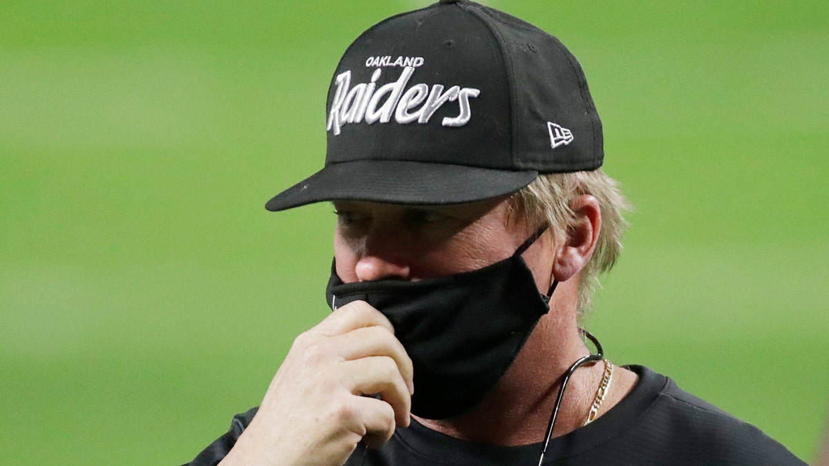 Las Vegas Raiders head coach Jon Gruden wears an Oakland Raiders hat before an NFL football game against the Los Angeles Chargers, Thursday, Dec. 17, 2020, in Las Vegas.