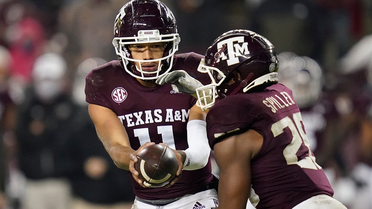 Texas A&amp;M quarterback Kellen Mond (11) hands the ball off to running back Isaiah Spiller (28) during the fourth quarter of an NCAA college football game against LSU, Saturday, Nov. 28, 2020, in College Station, Texas. (AP Photo/Sam Craft)