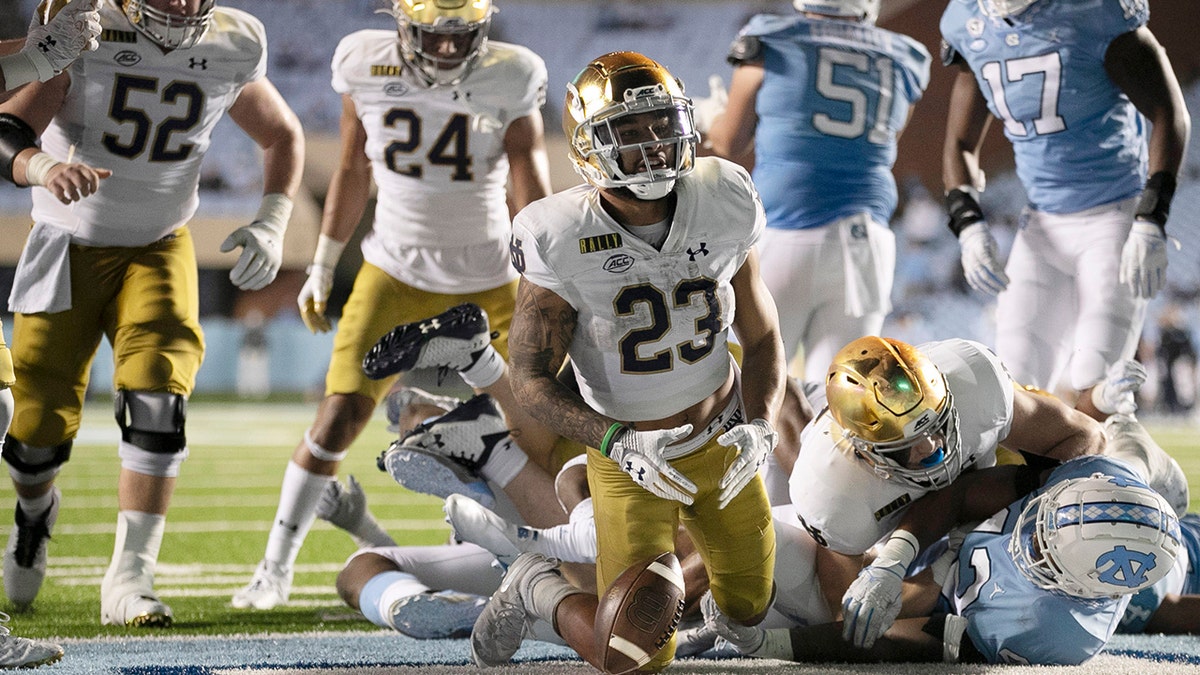 Notre Dame's Kyren Williams (23) reacts after scoring on a 1-yard carry against North Carolina during an NCAA college football game Friday, Nov. 27, 2020, in Chapel Hill, N.C. (Robert Willett/The News &amp; Observer via AP, Pool)