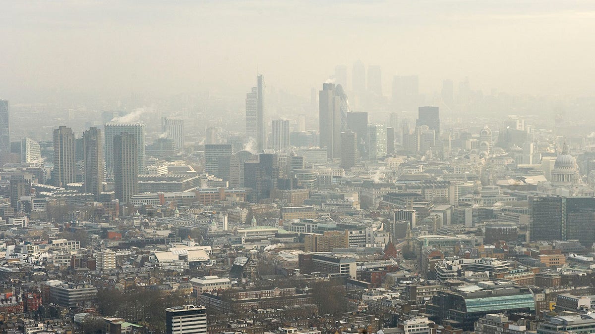 Aerial view of London's financial district in the fog.