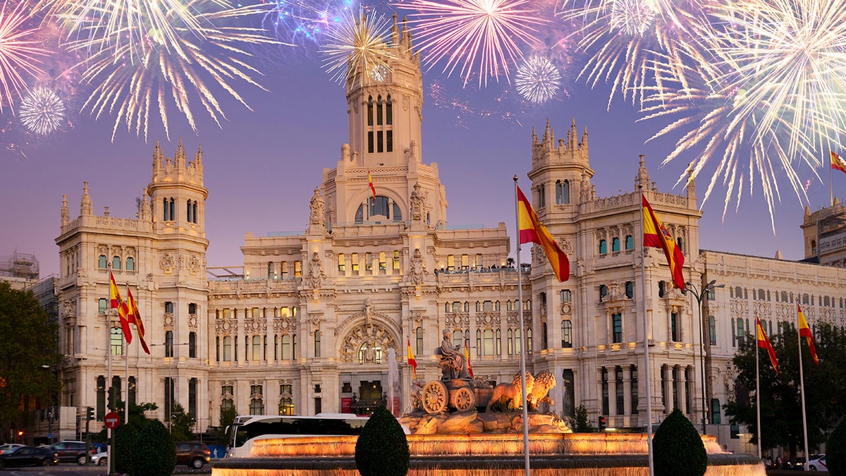 Fountain of the Cibeles and Palace of Communication, Culture and Citizenship Centre in the Cibeles Square of Madrid with fireworks