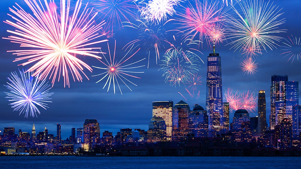Night time fireworks celebration over Hudson harbor to New York panorama view