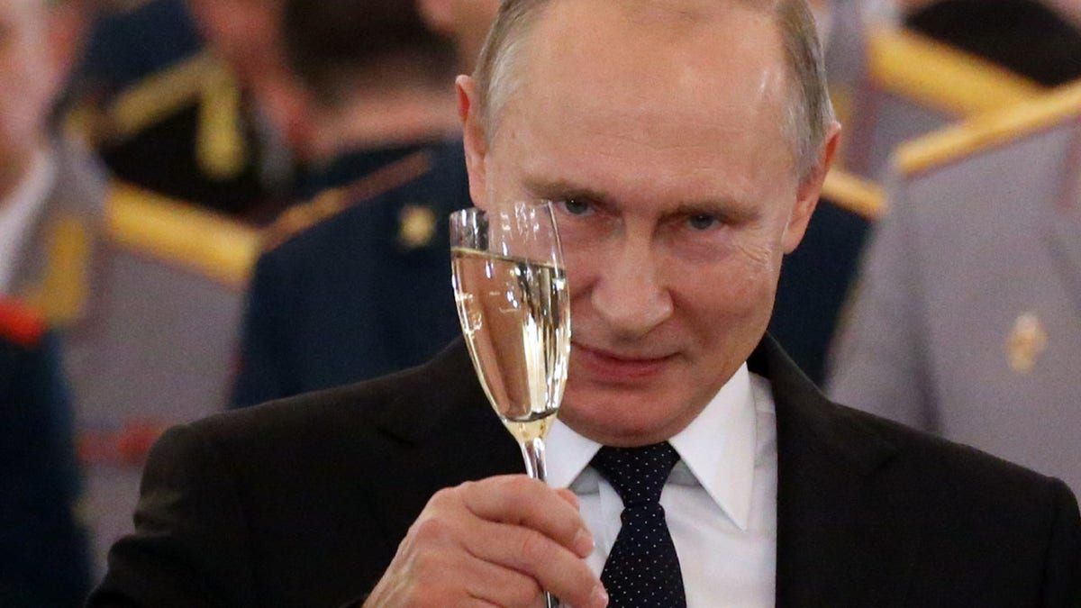 Russian President Vladimir Putin toasts during a reception for military servicemen who took part in the Syrian campaign, at Grand Kremlin Palace on Dec. 28, 2017, in Moscow, Russia. 