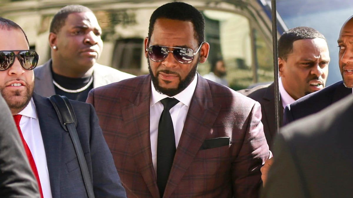 In this June 26, 2019 file photo, R&amp;B singer R. Kelly, center, arrives at the Leighton Criminal Court building for an arraignment on sex-related felonies in Chicago.