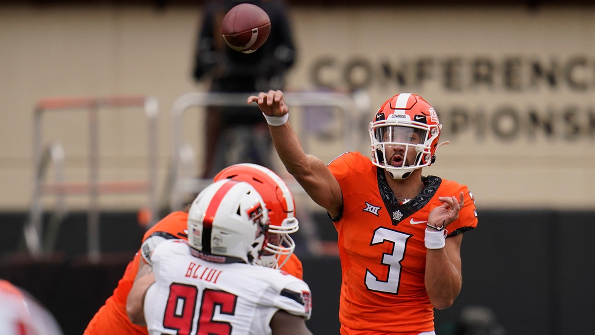 Oklahoma State quarterback Spencer Sanders (3) throws under pressure from Texas Tech defensive lineman Philip Blidi (96) in the first half of an NCAA college football game in Stillwater, Okla., Saturday, Nov. 28, 2020. (AP Photo/Sue Ogrocki)