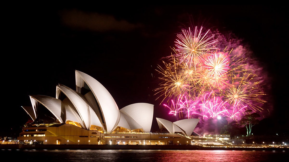Sydney, Australia - April 9, 2014: Fireworks erupt behind the Sydney Opera House at night, as part of a Madama Butterfly opera being staged on Sydney Harbour.