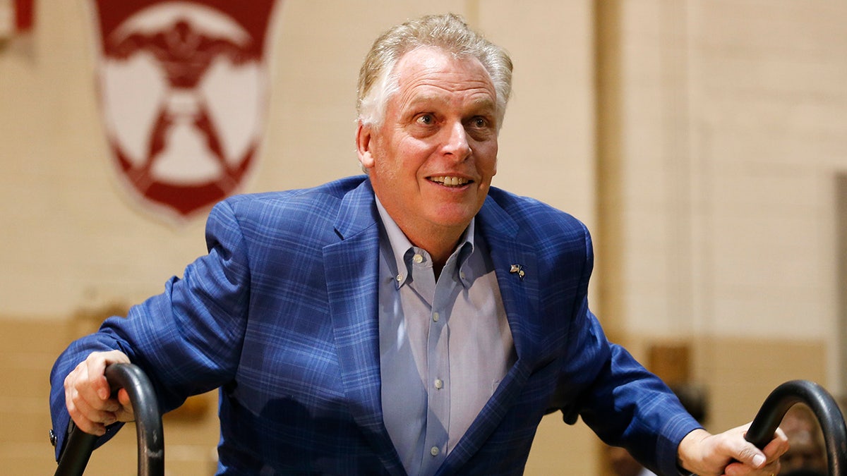 Former Virginia Gov. Terry McAuliffe walks up to the stage as he prepares to introduce Joe Biden. McAuliffe is trying to get his old job back. (AP Photo/Steve Helber, File)