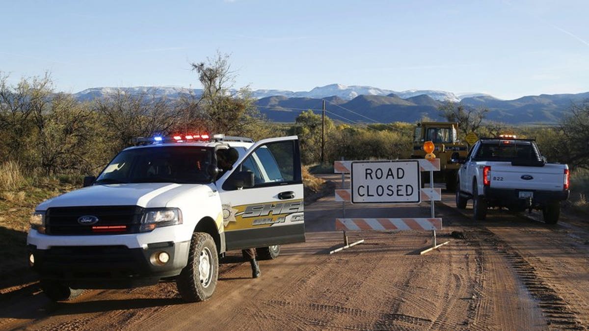 The road closed near Bar X road and Tonto Creek after a vehicle was washed by flood waters in Tonto Basin, Ariz. (Patrick Breen/The Arizona Republic via AP,File)