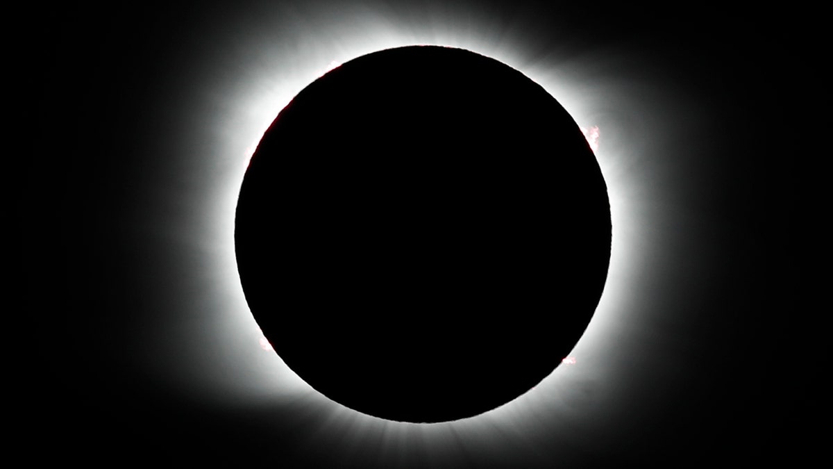 The moon covers the sun during a total solar eclipse in Piedra del Aguila, Argentina, Monday, Dec. 14, 2020.