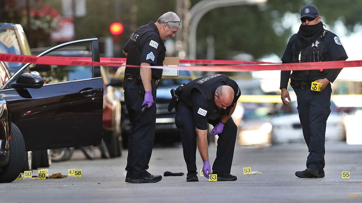 Chicago police investigate the scene of a shooting that killed rapper Carlton Weekly, known as FBG Duck, and wounded two others at 70 E. Oak St. in Chicago on August 4, 2020. (Chris Sweda/Chicago Tribune/Tribune News Service via Getty Images)