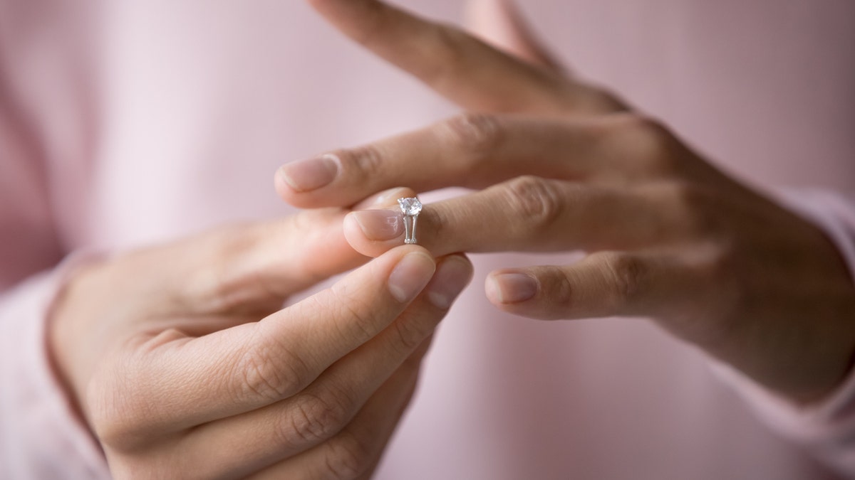 Photo of person taking ring off