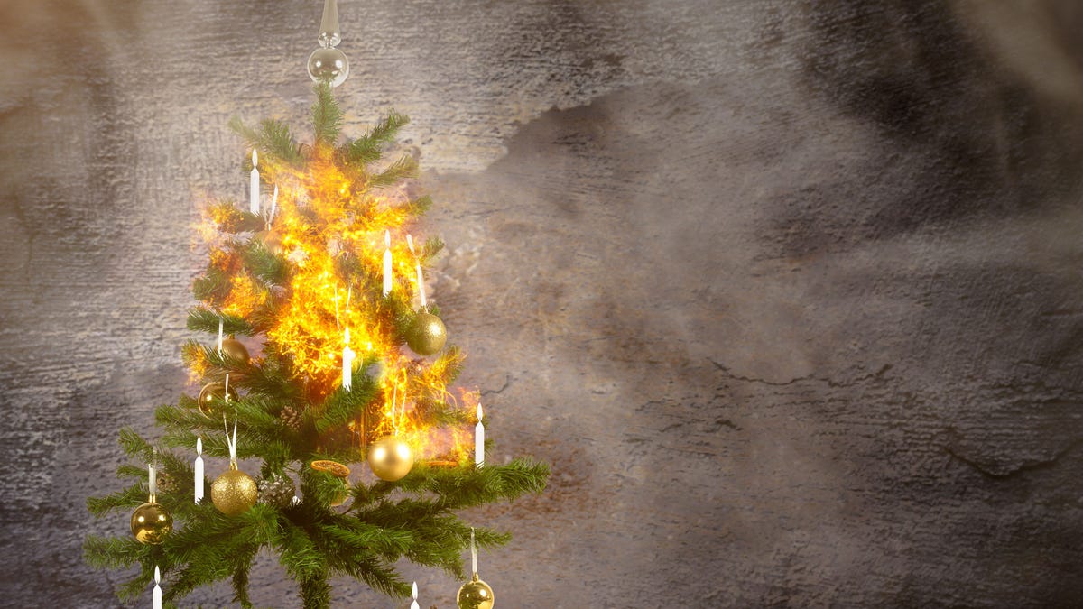 concept image of a burning christmas tree because of the candles