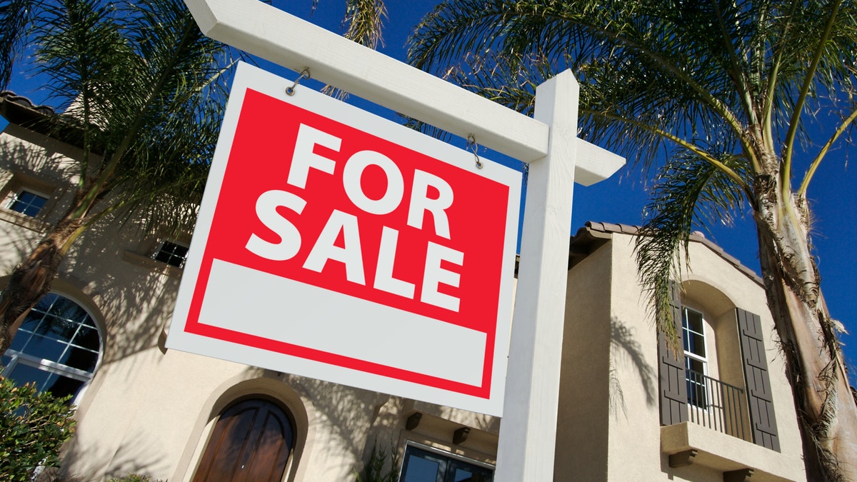 home for sale with sign in front