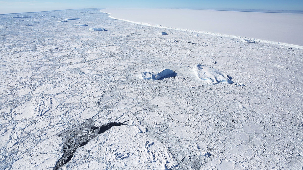 The western edge of the famed iceberg A-68 (TOP R), calved from the Larsen C ice shelf, is seen from NASA's Operation IceBridge research aircraft, near the coast of the Antarctic Peninsula region, on Oct. 31, 2017, above Antarctica. (Photo by Mario Tama/Getty Images)