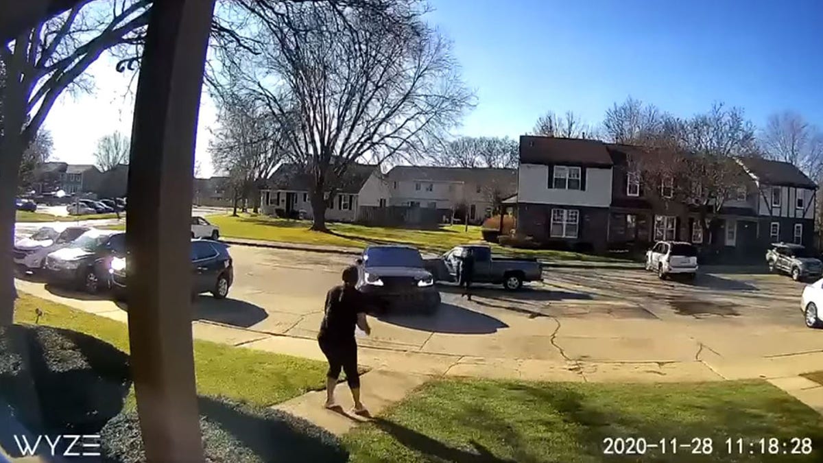 This still image from surveillance footage shows a gunman in a pickup truck drive behind and block the victim from pulling out of a parking spot at a condominium before opening fire in Sterling Heights, Mich., on Saturday.