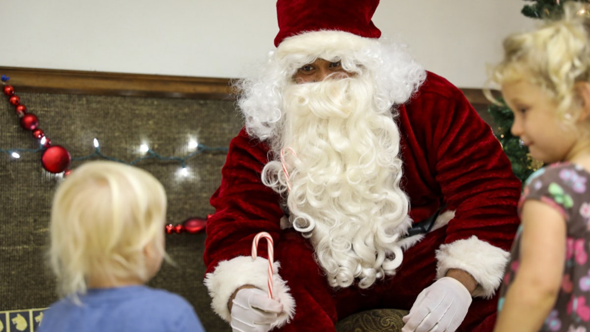 Sgt. 1st Class Peniamina Feleti, an infantryman with 1st Battalion, 27th Infantry Regiment "Wolfhounds", 2nd Infantry Brigade Combat Team, 25th Infantry Division, acts as Santa Claus during a holiday party to benefit the Holy Family Home orphanage on December 4, 2020, at Schofield Barracks, Hawaii. 1-27 IN and the Holy Family Home orphanage in Osaka, Japan, have an enduring relationship dating back to just after World War II, when soldiers took up a collection for the orphanage during the holiday season in 1949.