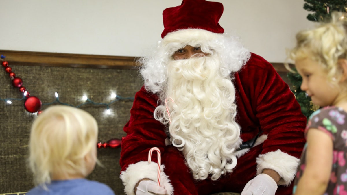 Sgt. 1st Class Peniamina Feleti, an infantryman with 1st Battalion, 27th Infantry Regiment "Wolfhounds", 2nd Infantry Brigade Combat Team, 25th Infantry Division, acts as Santa Claus during a holiday party to benefit the Holy Family Home orphanage on December 4, 2020, at Schofield Barracks, Hawaii. 1-27 IN and the Holy Family Home orphanage in Osaka, Japan, have an enduring relationship dating back to just after World War II, when soldiers took up a collection for the orphanage during the holiday season in 1949.