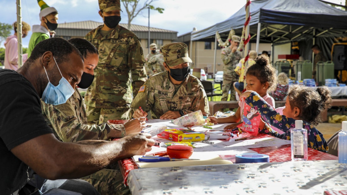 Soldiers and Families with 1st Battalion, 27th Infantry Regiment "Wolfhounds", 2nd Infantry Brigade Combat Team, 25th Infantry Division, create gifts and ornaments to send to the Holy Family Home orphanage on December 4, 2020 at Schofield Barracks, Hawaii. 1-27 IN and the Holy Family Home orphanage in Osaka, Japan, have an enduring relationship dating back to just after World War II, when Soldiers took up a collection for the orphanage during the holiday season in 1949.