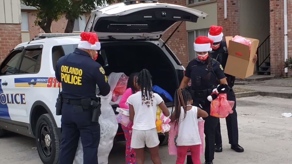 Orlando police officers donated toys and gifts to more than 200 children in need and delivered them on Saturday.