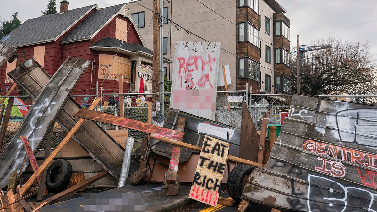 Barriers surround the Red House, whose residents are up for eviction, on December 10, 2020 in Portland, Oregon. Police and protesters clashed during an attempted eviction Tuesday morning, leading protesters to establish a barricade around the Red House. (Photo by Nathan Howard/Getty Images)