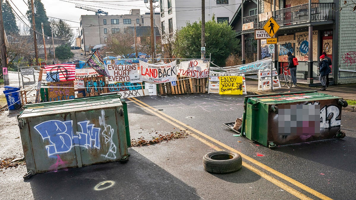 Barriers surround the Red House, whose residents are up for eviction, on December 10, 2020 in Portland, Oregon. Police and protesters clashed during an attempted eviction Tuesday morning, leading protesters to establish a barricade around the Red House. (Photo by Nathan Howard/Getty Images)
