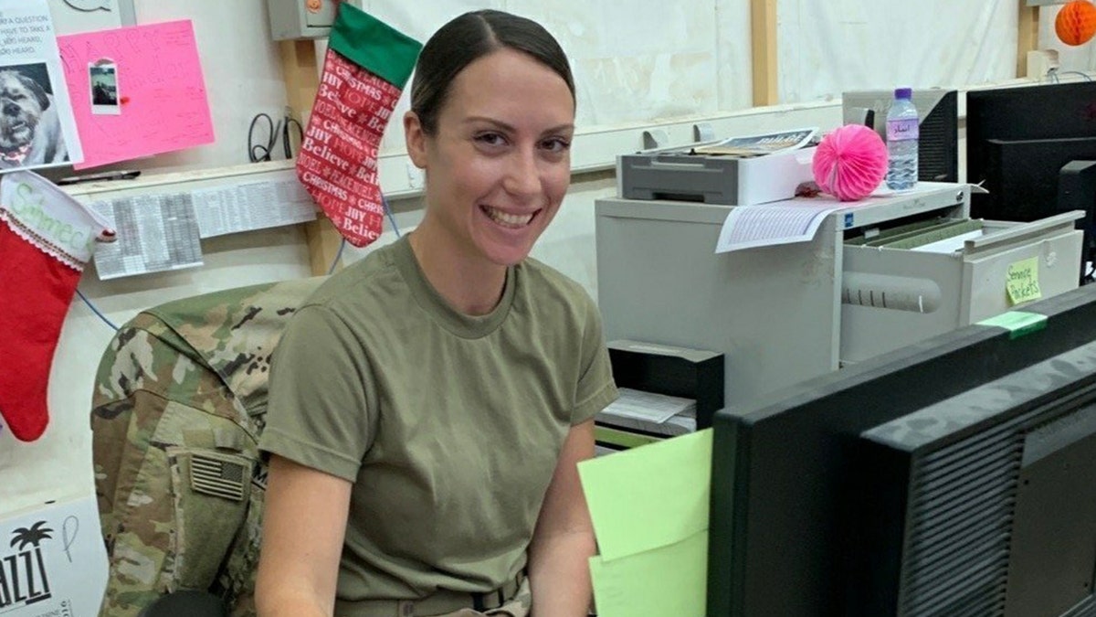 U.S. Army Spc. Anna Schmeck, automated logistical specialist with Headquarters Support Company, 628th Aviation Support Battalion, 28th Expeditionary Combat Aviation Brigade, poses for a photo while at work at a motor pool in the 28th ECAB's area of operations in the Middle East.