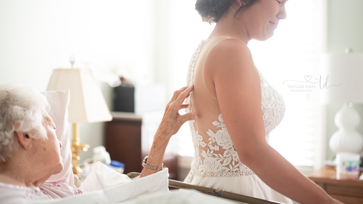 The bride cried as her grandmother touched the detailing on her back.